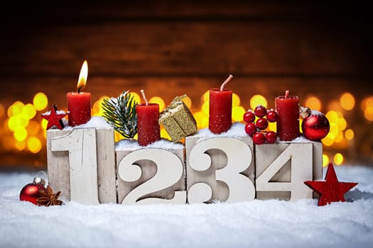first sunday in advent concept xmas light wooden background with candles ball bauble stars