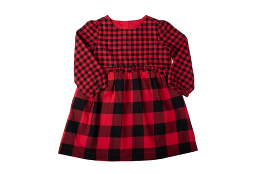 Clothes for children. A beautiful red and black checkered girl dress isolated on a white background. Children fashion.