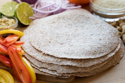 Whole wheat tortillas and fresh ingredients for Mexican cooking.