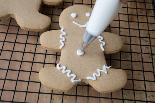 Decorating gingerbread men for Christmas