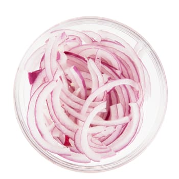Sliced red onions in a glass bowl isolated on white and viewed from above
