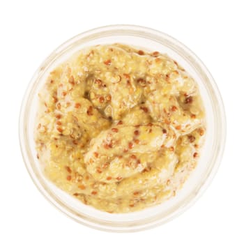 Stone ground mustard in a glass bowl, isolated on white and viewed from above.