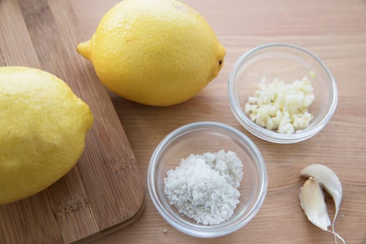 Cooking with lemon and garlic, flat lay with copy space.