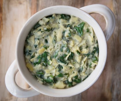 Flat lay of vegan spinach artichoke dip in bowl
