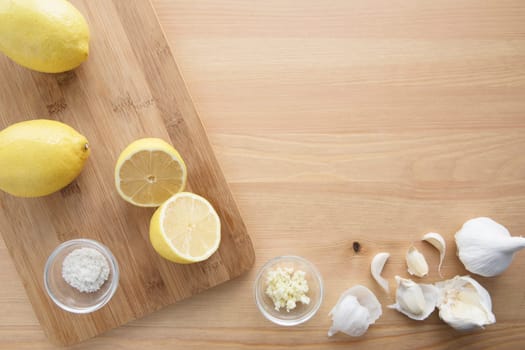 Cooking with lemon and garlic, flat lay with copy space.