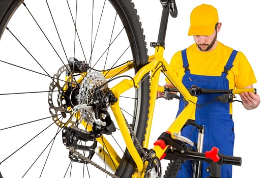 bicycle mechanic straightening handlebar on mountain bike