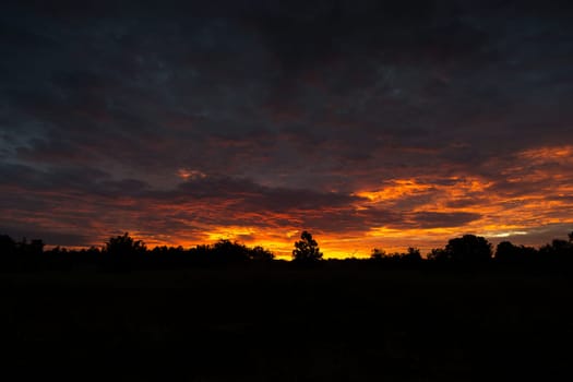 Sunrise, landscape with clouds and silhouette in the morning