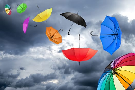 flying umbrellas in front of dark sky