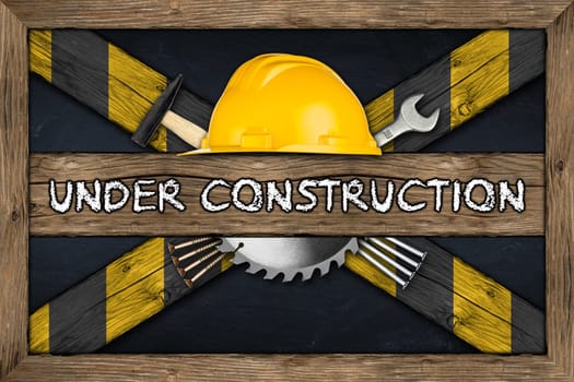Under Construction concept on blackboard