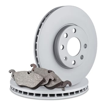 pair of car brake discs and pads on white background