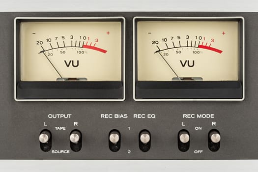 close up of two retro vu meter and switches