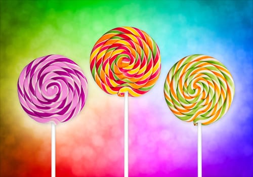 three lolly pops in front of colorful background