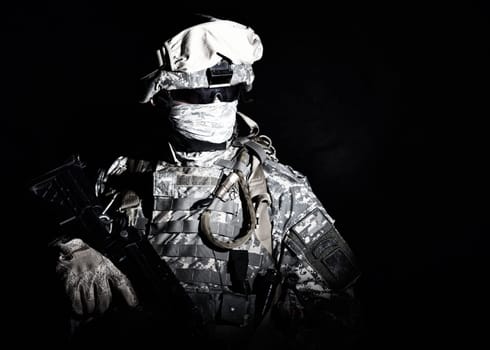 Armed infantry with hidden face standing during combat, counter terrorist night raid, protected perimeter control, state border patrolling and protecting