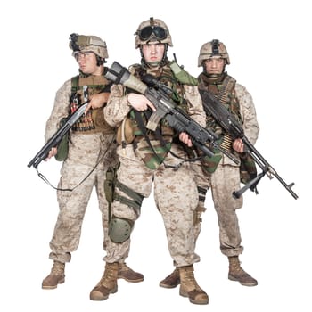 Full length group portrait of army special operations forces soldiers, marines in combat uniform and tactical ammunition, armed with service rifle, shotgun and middle machine gun isolated studio shoot