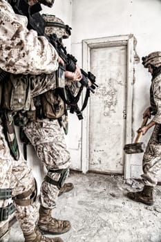 Marine assault team, counter-terrorism squad members, commando fighters in body armor, armed with service rifles, stalking through corridor to closed door, clearing rooms in abandoned city building