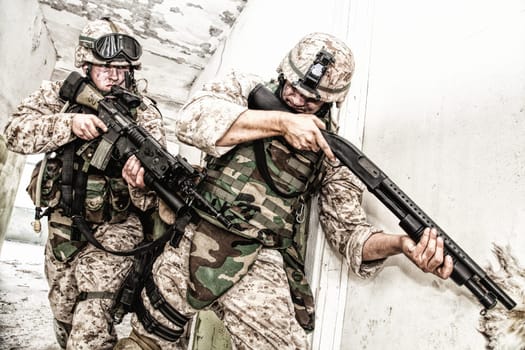 Marine assault team, counter-terrorism squad members, commando fighters in body armor, armed with service rifles, stalking through corridor to closed door, clearing rooms in abandoned city building