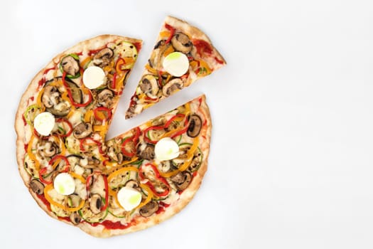 Vegetarian pizza with a cut slice seen from above garnished with mushrooms and mozzarella with its ingredients on white background, seen from above