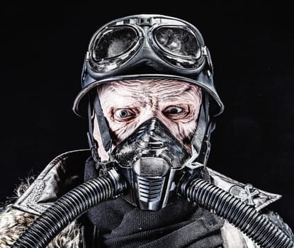 Ugly face of Futuristic nazi soldier in gas mask and steel helmet. Skin burned by atomic flame