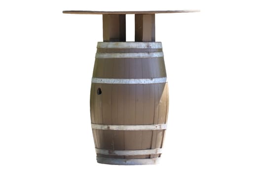 Table isolated. A brown wooden barrel for wine with iron rings used as table in the outdoor area in a leisure park isolated on a white background.
