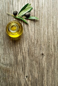Bottle of Extra virgin healthy Olive oil with fresh olives close up