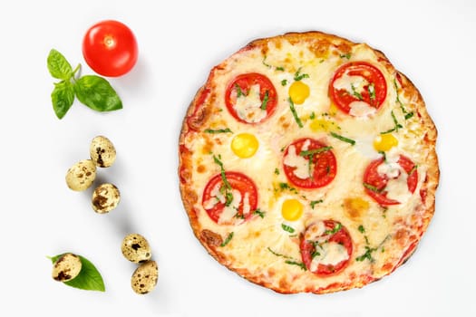 Pizza caprese top view with quail eggs with tomato and basil leaves beside, on white background