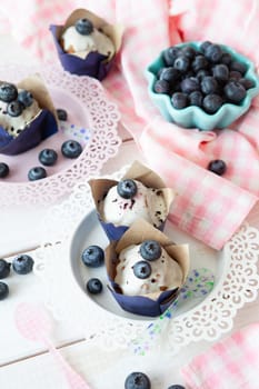 Yummy little muffins with blueberries and sugar frosting