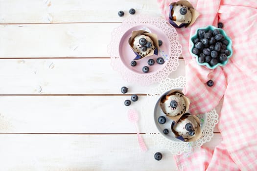 Yummy little muffins with blueberries and sugar frosting