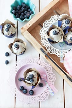 Yummy little muffins with blueberries and sugar frosting