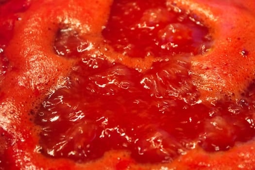 Closeup of tomato sauce boiling and reducing down.