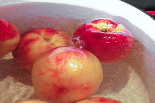 Closeup of of peaches in boiling water