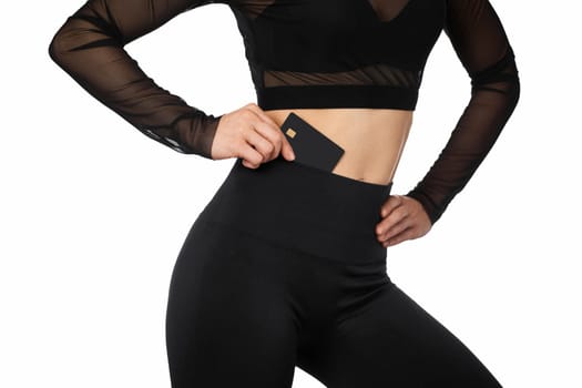 athletic fitness woman with black premium credit bank card on white background.