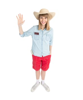 Happy lady tourist in blue shirt red shorts and straw hat. Girl going to travel. Isolated on white background. Interesting trip on summer vacation. Woman greeting to somebody.
