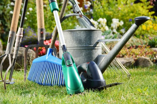Watering can and tools in the garden
