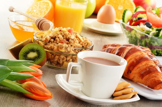 Breakfast with coffee, juice, croissant, salad, muesli and egg. Swedish buffet