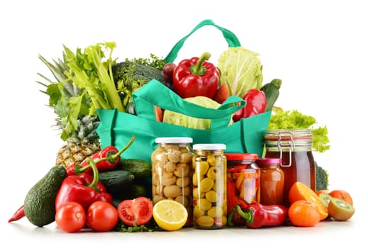 Green shopping bag with groceries isolated on white background