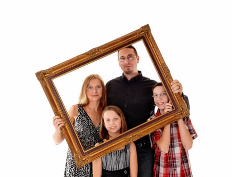 A young lovely family standing for white background and holding a.picture frame in front of them..
