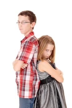 A tall brother and small sister standing back to back isolated for white.background and are mad to each other..