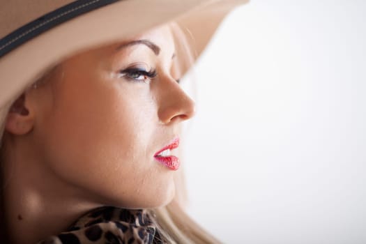 beautiful blonde young woman with red lips long eyelashes and a hat
