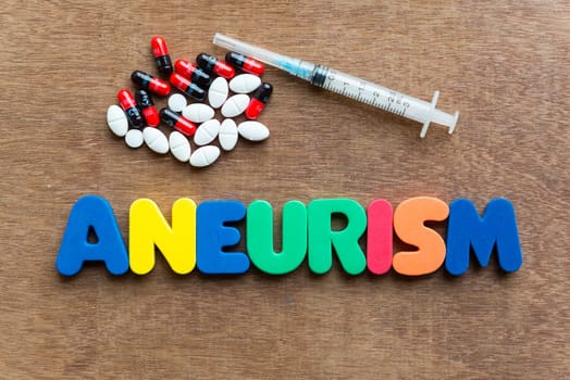 aneurism colorful word in the wooden background