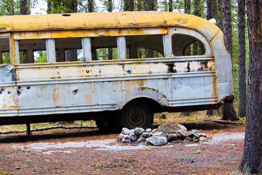 Stripped abandoned bus at a hunters camp on crown land.
