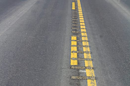 Closeup view of center rumble strips on a highway.