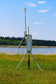 A weather monitoring station beside a river.