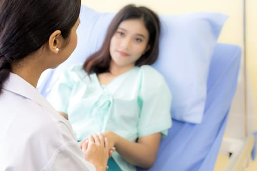 medical doctor holding patient's hands to cheer up patient