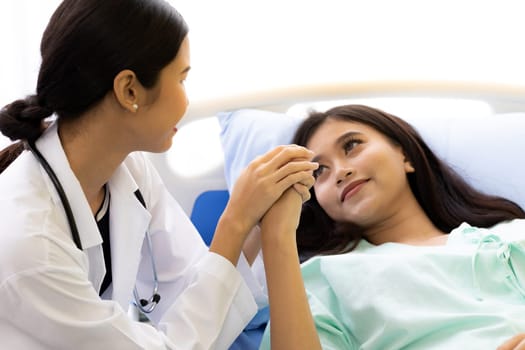 medical doctor holding patient's hands to cheer up patient (Selective focus at hand)
