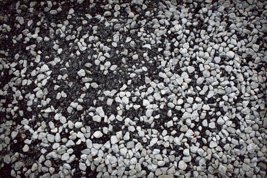 Mixture of gravel stones on the road