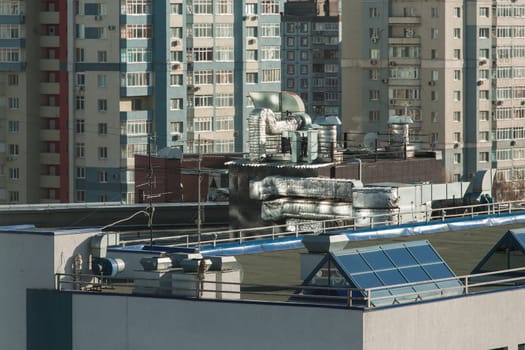 Exhaust vents of industrial air conditioning and ventilation units. Skyscraper roof top in Tokyo, Japan.