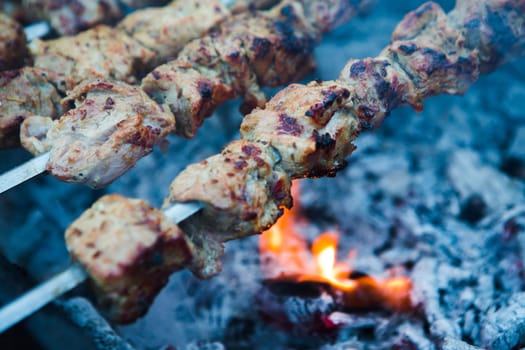 A barbecue meat slices prepare on fire