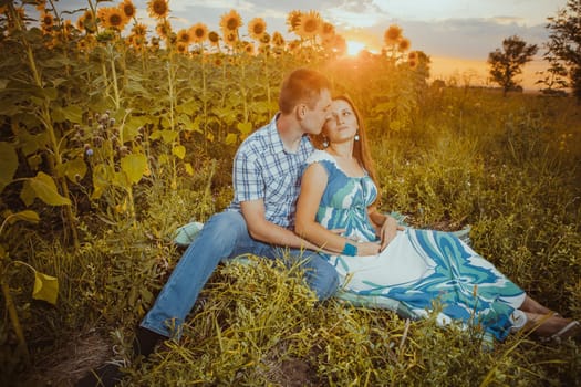 Beautiful couple having fun in sunflowers fields