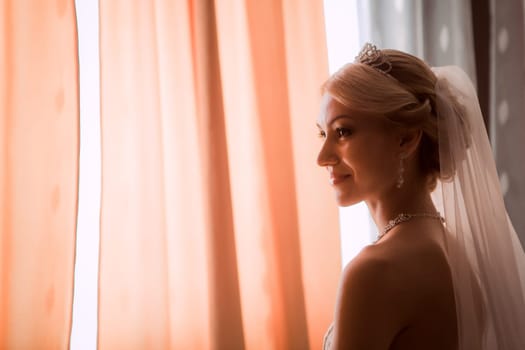bride in a beautiful dress near the window