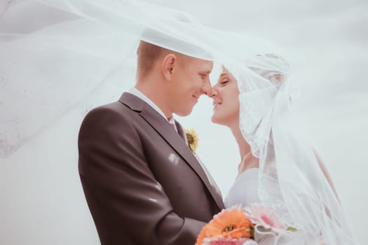 Kissing wedding couple in high grass